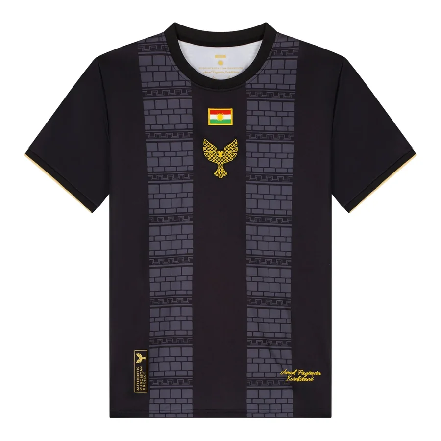Amed away shirt in black and gold with the pattern of the basalt walls, front view